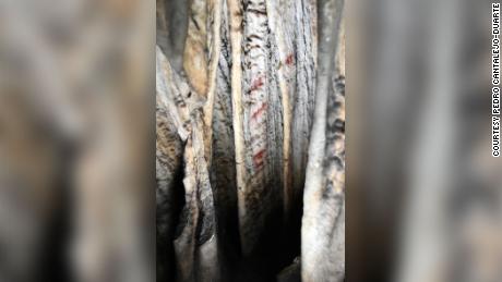 Here is a close-up view of one of the curtains with red markings in Cueva de Ardales.