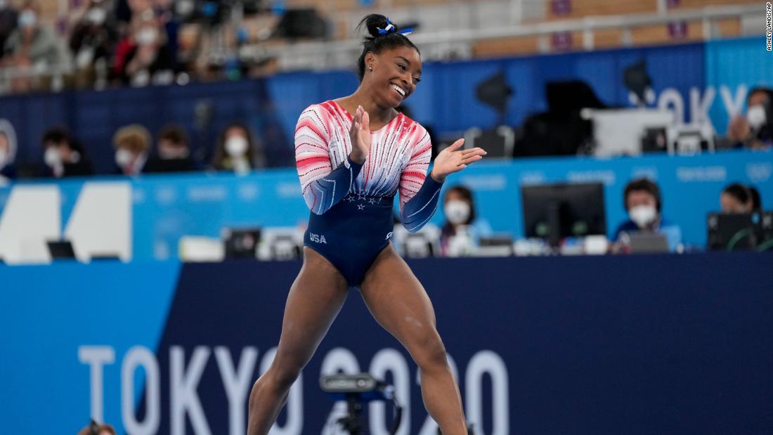 Biles claps after finishing her routine Tuesday.