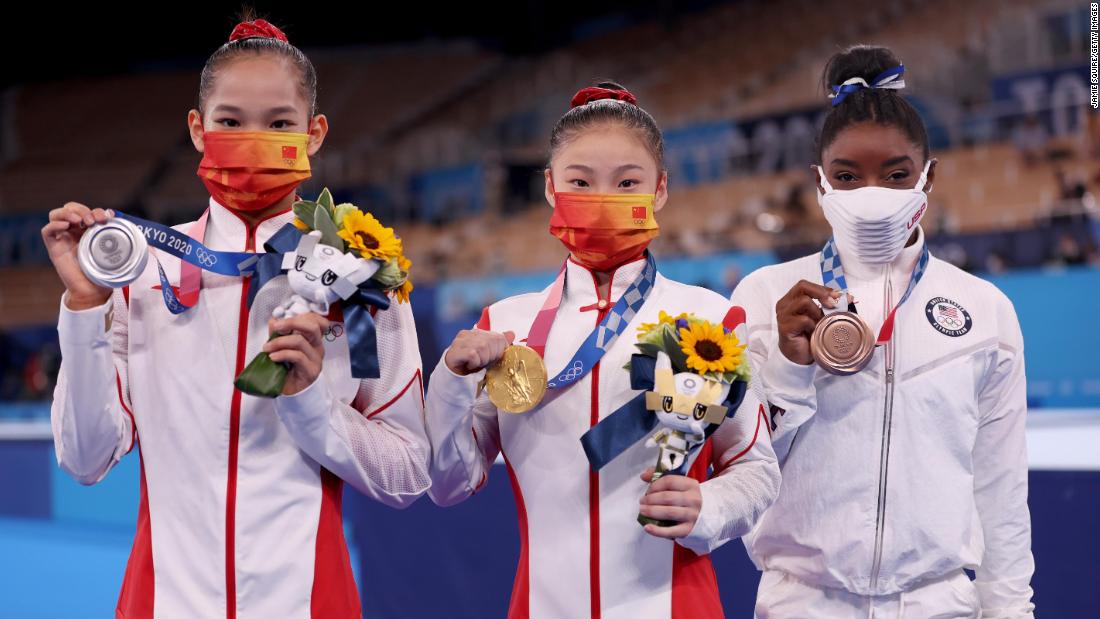 From left, Tang, Guan and Biles pose with their medals.