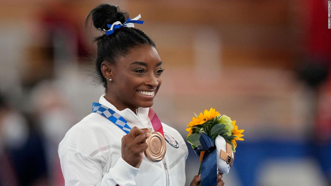 Biles poses with her bronze medal Tuesday. &quot;It definitely feels more special, this bronze, than the balance beam bronze at Rio,&quot; she said. &quot;I will cherish it for a long time.&quot; Biles now has seven Olympic medals, tying her with Shannon Miller for the most by an American gymnast.