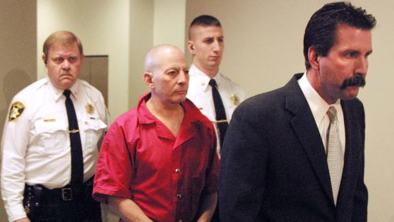 Durst, center, is escorted by Northampton County deputy sheriffs Dave Falco, rear left, and Keith Border, center rear, to a Northampton County courtroom before a hearing advising Durst of his rights under extradition laws in December 2001.