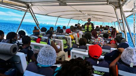 Stranded migrants from Cuba, Haiti and several African countries travel on a boat from Necocli to Capurgana, Colombia, on July 31, 2021. 