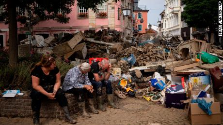 People take a break from cleaning up after flooding in Bad Neuenahr-Ahrweiler, Germany, in July.