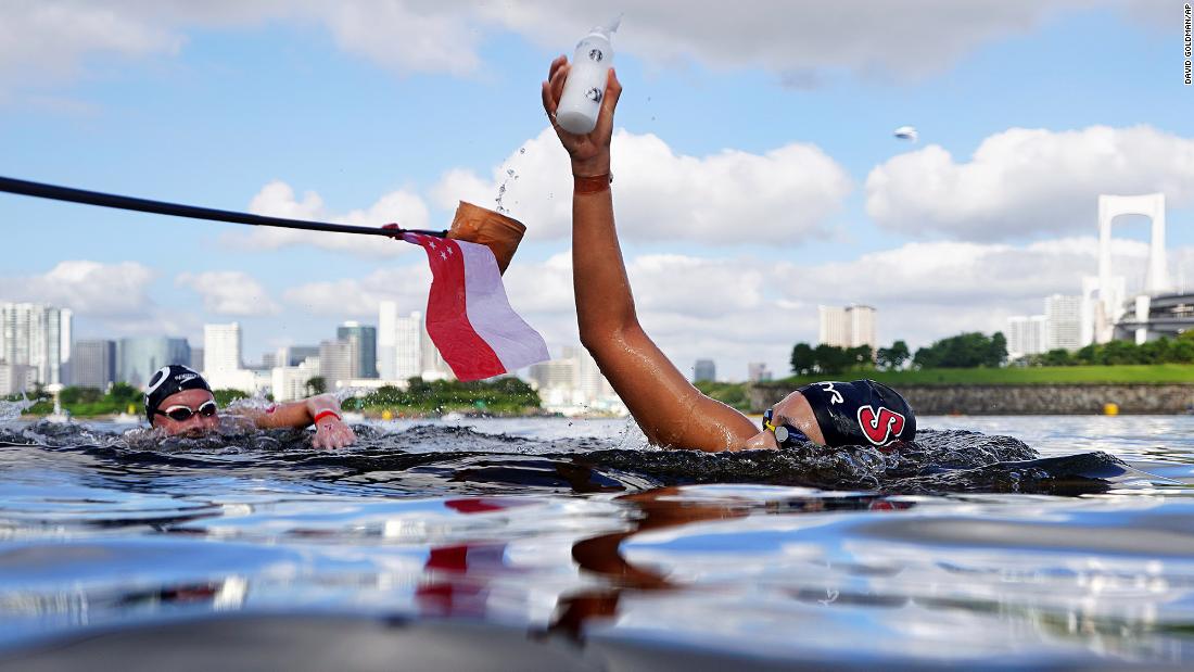 Singaporean swimmer Li-Shan Chantal Liew grabs a drink while competing in the 10-kilometer open-water event on August 4.