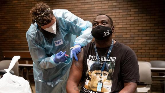 Stacy Winston, right, receives a dose of the Johnson & Johnson COVID-19 vaccine from Cody Killion, relief manager and medical assistant for HRSupport, during a COVID-19 vaccination walk-in clinic hosted by the City of Springfield and the Illinois Dept. of Public Health at the Lincoln Library in Springfield, Ill., Friday, July 30, 2021.