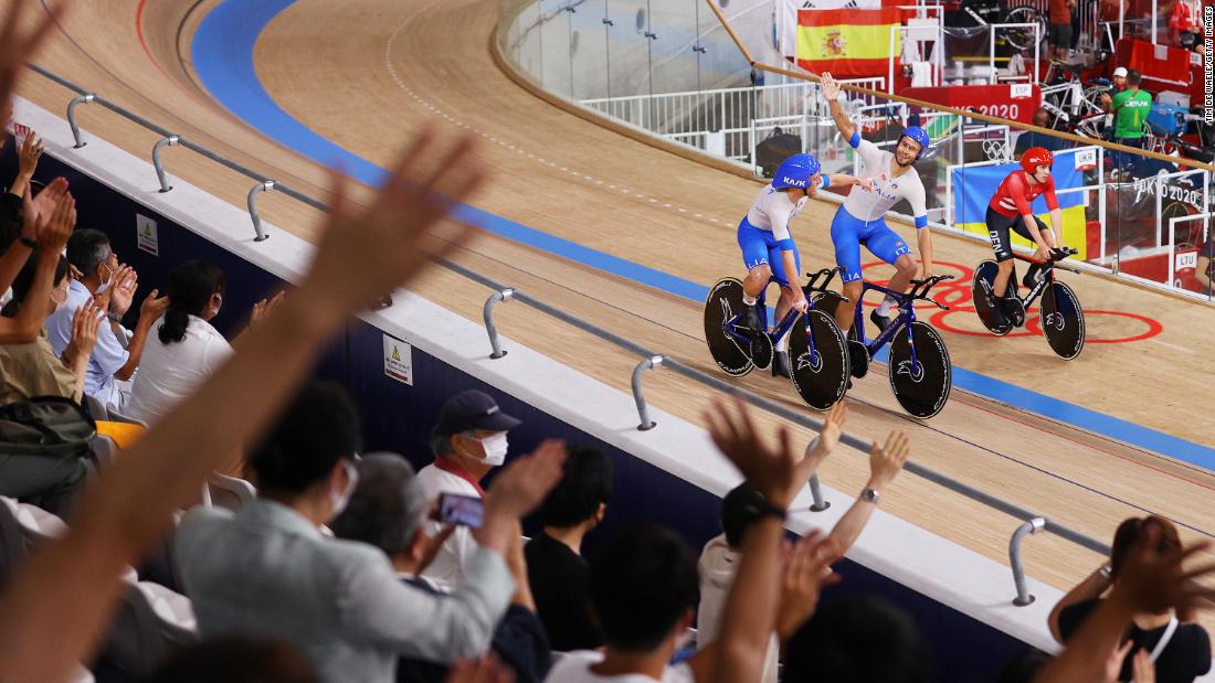 From left, Italy&#39;s Simone Consonni and Filippo Ganna celebrate after &lt;a href=&quot;https://www.cnn.com/world/live-news/tokyo-2020-olympics-08-04-21-spt/h_78cf746b97bccd1690781b8701b0f329&quot; target=&quot;_blank&quot;&gt;setting a new world record&lt;/a&gt; and winning a gold medal in the team pursuit event on August 4.