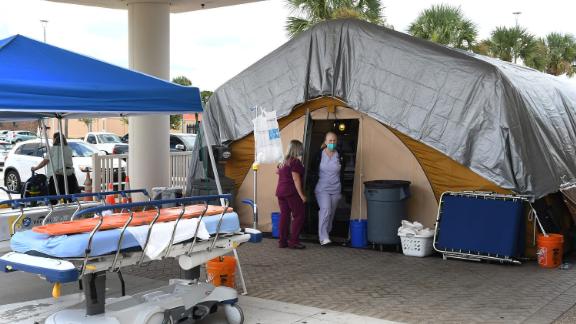 MELBOURNE, FLORIDA, UNITED STATES - 2021/07/29: Nurses are seen at a treatment tent outside the emergency department at Holmes Regional Medical Center in Melbourne. The tent was set up to serve as an overflow area as the number of COVID-19 infections surges throughout Brevard County, Florida due to the Delta variant and large numbers of unvaccinated residents. (Photo by Paul Hennessy/SOPA Images/LightRocket via Getty Images)