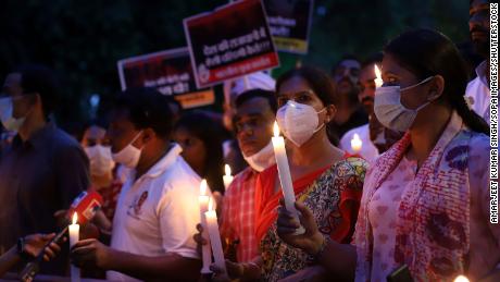 Protesters march with lit candles and placards on August 4 in Delhi, India. 