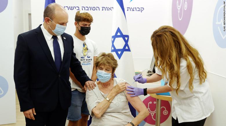 Prime Minister Naftali Bennett accompanies his mother for her booster shot in Haifa on Tuesday.