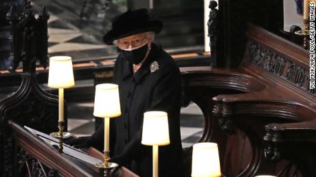 Queen Elizabeth II watches as porters carry Prince Philip's casket into St. George's Chapel on April 17, 2021.