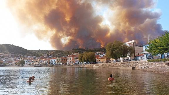 Smoke and flames rise over the village of Limni on the Greek island of Evia, on August .
