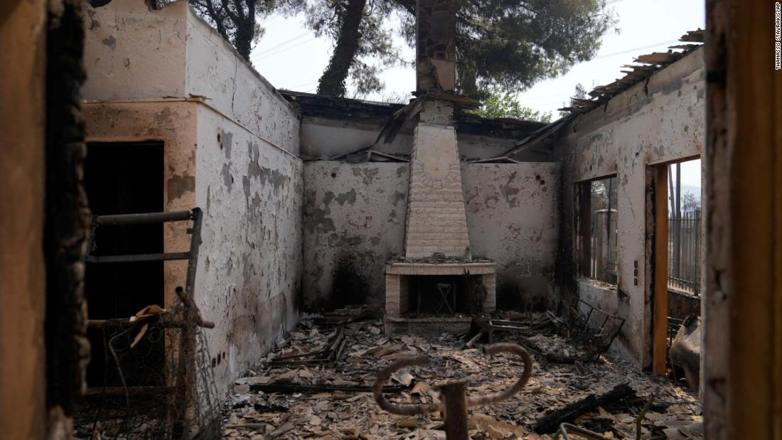 The remnants of a destroyed house are seen in the Varibobi area of northern Athens on August 4.