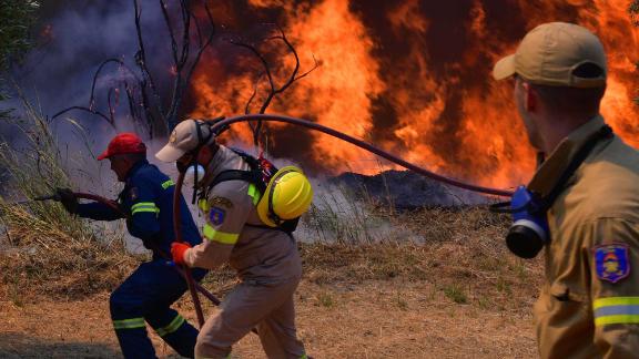 Firefighters try to extinguish a wildfire near the town of Olympia, Greece on August 5.