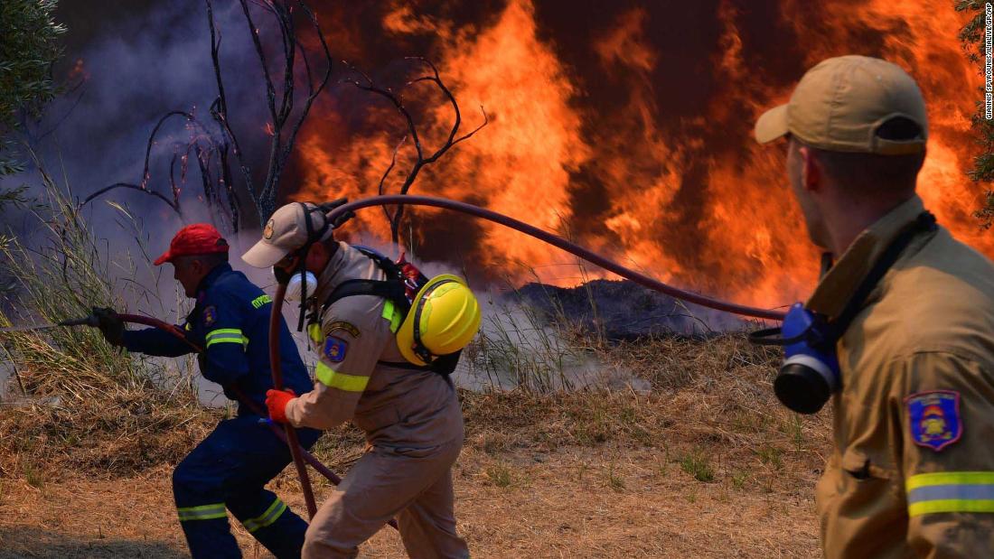 Firefighters try to extinguish a wildfire near the town of Olympia, Greece, on August 5.