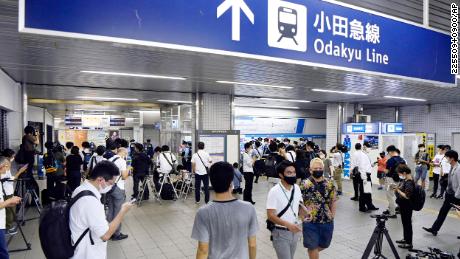 Police and media gather at Soshigaya-Okura Station in Tokyo on Friday following the incident.