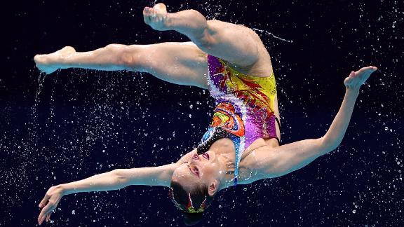 A Russian artistic swimmer competes in the team event on August 7. <a href=