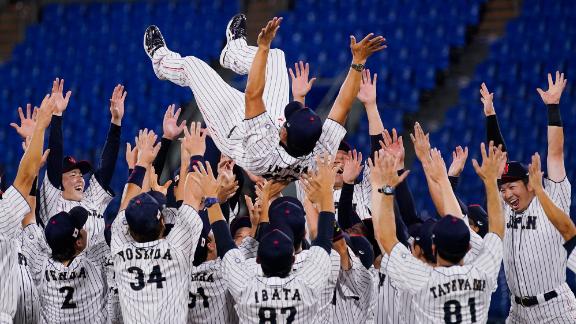 Japan's baseball team celebrates with manager Atsunori Inaba after <a href=