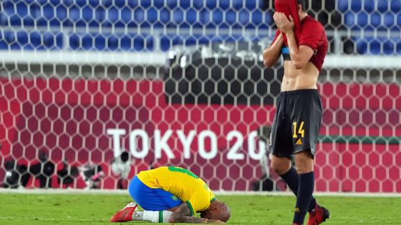 Brazilian defender Dani Alves, left, and Spanish midfielder Carlos Soler react after <a href=