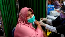 A woman receives a Sinovac vaccine in Banda Aceh, Indonesia. With less than 8% of its population fully vaccinated, Indonesia has overtaken India as Asia&#39;s new covid epicenter.