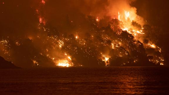 Wildfire approaches the seaside village of Limni, on the Greek island of Evia, on August 6.