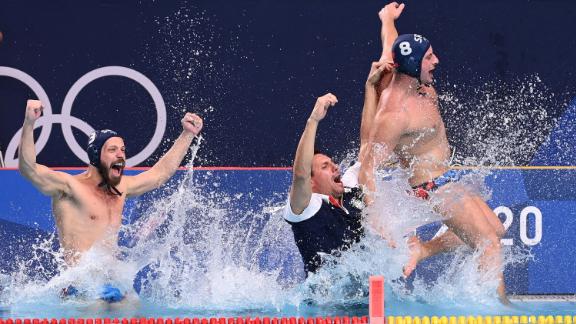 Serbia's Nikola Dedović, Vladimir Vujasinović and Milan Aleksić jump into the pool as they celebrate winning <a href=