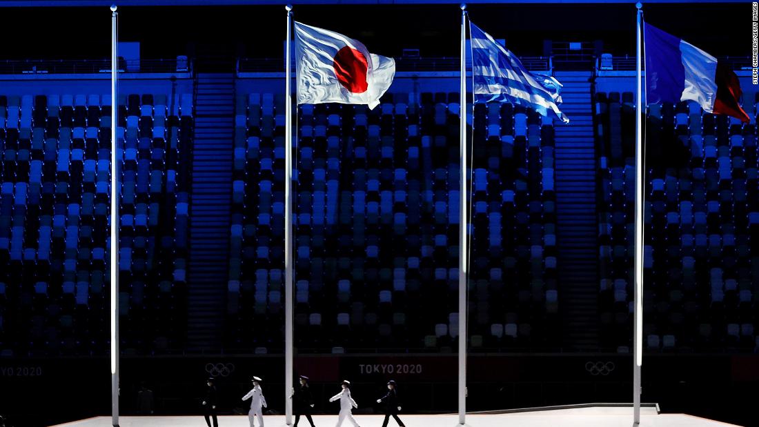 The national flags of Japan, Greece and France fly during the closing ceremony. Greece is the birthplace of the Olympic Games. France will host the 2024 Summer Olympics.
