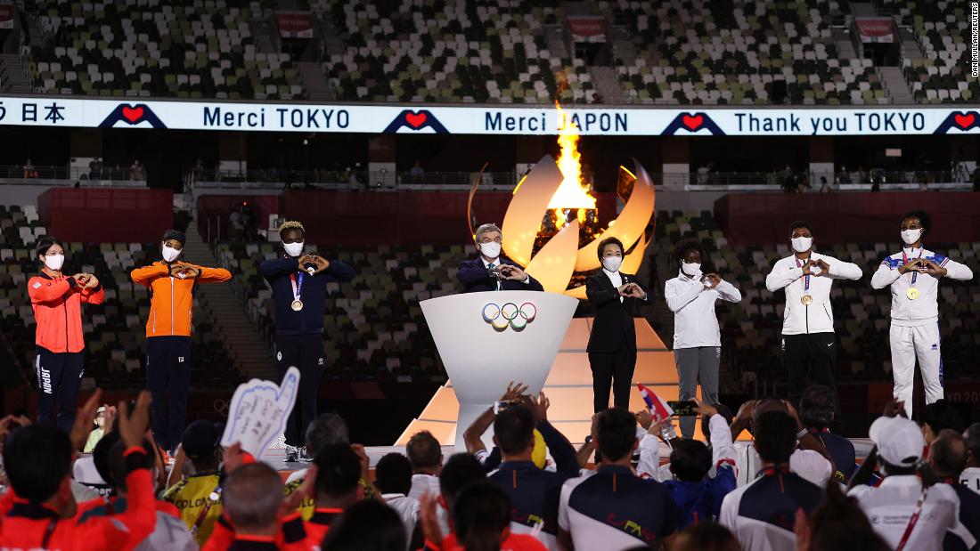 Thomas Bach, the president of the International Olympic Committee, makes a heart gesture as he delivers a speech at the closing ceremony. In his speech, Bach thanked the athletes and the Japanese people for their hard work and sacrifices in staging the most logistically challenging Olympic Games in history. &quot;We did it together,&quot; he said.