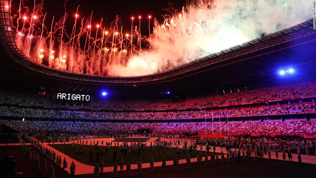 Fireworks explode over Tokyo&#39;s National Stadium at the end of the Olympics&#39; closing ceremony on Sunday, August 8. The word &quot;arigato,&quot; seen at left, means thank you in Japanese.