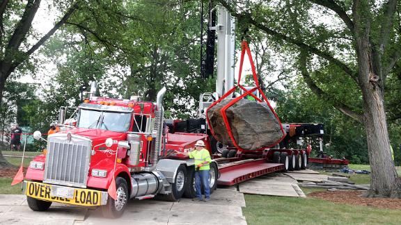 A crane operator slowly maneuvers Chamberlin Rock onto a flatbed trailer on campus on Friday.