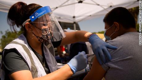 A 12-year-old receives a first dose of the Pfizer Covid-19 vaccine at a mobile vaccination clinic during a back to school event in Los Angeles.