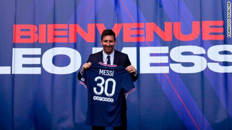 Lionel Messi holds his jersey after a press conference Wednesday, Aug. 11, 2021 at the Parc des Princes stadium in Paris. Lionel Messi said he&#39;s been enjoying his time in Paris &quot;since the first minute&quot; after he signed his Paris Saint-Germain contract on Tuesday night. The 34-year-old Argentina star signed a two-year deal with the option for a third season after leaving Barcelona. (AP Photo/Francois Mori)