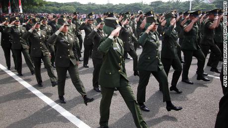 Female Indonesian soldiers march during the celebration of the 70th anniversary of Indonesian military on October 05, 2015 in Banda Aceh, Indonesia. 
