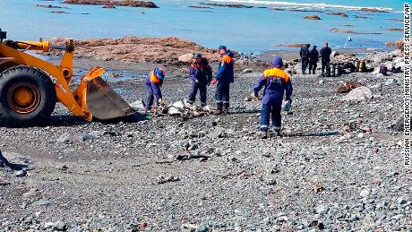 Emergency personnel work near the site where a helicopter carrying tourists crashed at Kurile Lake in the Kronotsky nature reserve on the Kamchatka Peninsula in Russia on Thursday.