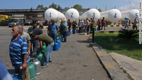 Lebanese wait to fill their gas cylinders in the southern city of Sidon, on August 10.