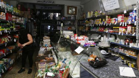 A woman shops in a store without electricity due to shortages in Beirut on August 11.