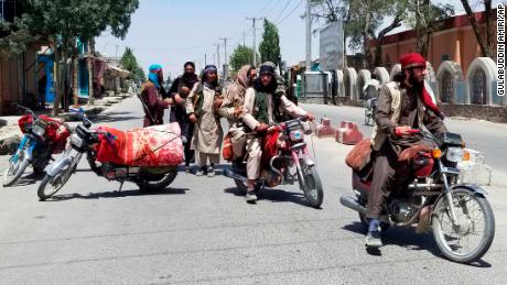 Taliban fighters are shown patrolling the city of Ghazni on Thursday.