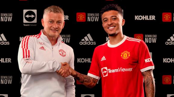 Jadon Sancho shakes hands with Manchester United manager Ole Gunnar Solskjaer after signing with the club. 