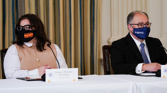 Jess Morales Rocketto, civic engagement director of the National Domestic Workers Alliance, (left), and Ramiro Cavazos, president and CEO of the US Hispanic Chamber of Commerce, listen as President Joe Biden speaks during a meeting with Latino leaders in the White House on August 3, 2021.