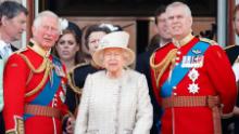 The Queen stands with Princes Charles and Andrew during a flypast of Buckingham Palace in 2019. 