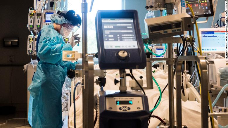 Nichole Arevalo, an R.N. at the downtown campus of NCH in Naples, Florida, treats a Covid-19 patient in the Intensive Care Unit on August 9, 2021. 