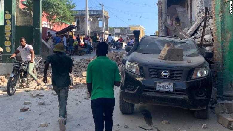 Buildings and cars were damaged in Les Cayes, Haiti.