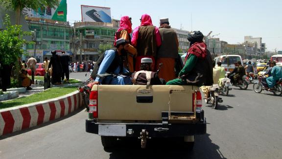 Taliban fighters sit on the back of a vehicle in the city of Herat, west of Kabul on Saturday. 