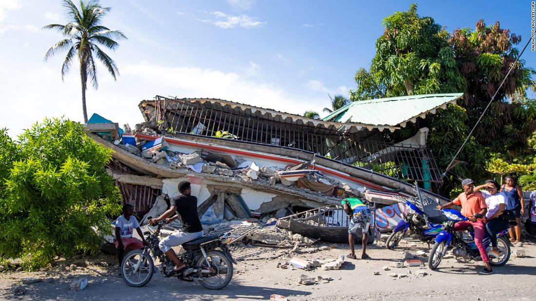 People stop and observe the aftermath of the earthquake in Saint-Louis-du-Sud, in southern Haiti.