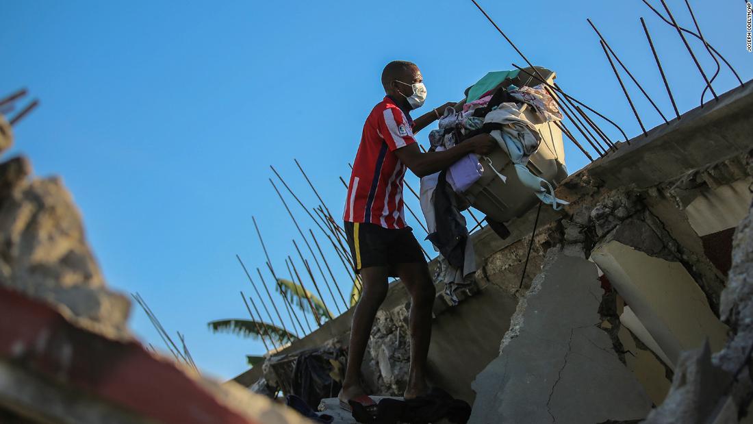 A man recovers belongings from his home, which was destroyed by the earthquake August 14.