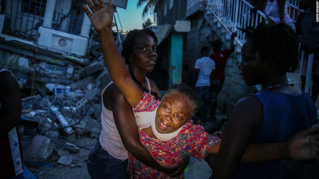 Oxiliene Morency cries out in grief after the body of her 7-year-old-daughter, Esther Daniel, was recovered from the rubble of their home in Les Cayes on Saturday, August 14.