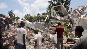 TOPSHOT - People search through the rubble of what used to be the Manguier Hotel after the earthquake hit on August 14, 2021 in Les Cayes, southwest Haiti. - Rescue workers scrambled to find survivors after a powerful 7.2-magnitude earthquake struck Haiti early Saturday, killing at least 304 and toppling buildings in the disaster-plagued Caribbean nation still recovering from a devastating 2010 quake.
The epicenter of the shaking, which rattled homes and sent terrified locals scrambling for safety, was about 100 miles (160 kilometers) by road west of the center of the densely populated capital Port-au-Prince. (Photo by Stanley LOUIS / AFP) (Photo by STANLEY LOUIS/AFP via Getty Images)