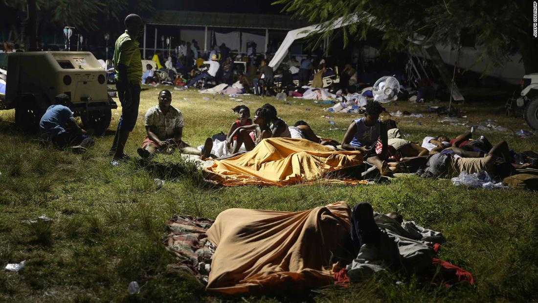 People displaced from their homes spend the night outside a hospital in Les Cayes on August 14.