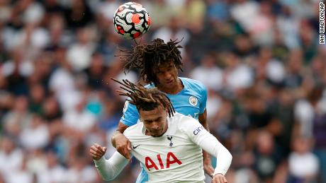 Manchester City&#39;s Nathan Ake, top, jumps for the ball with Tottenham&#39;s Dele Alli.