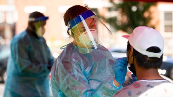 A healthcare worker administers a Covid-19 test at a testing site in Mifflin Square Park in Philadelphia Thursday.