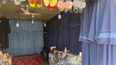 Burqas hang in a market in Kabul on July 31. The price has surged as women rush to cover themselves to avoid attracting the militants&#39; attention.